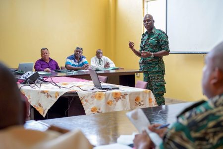 Director General of the CDC, Lieutenant Colonel, Kester Craig (right) engaging members of the Upper Demerara - Berbice (Region Ten), Regional Disaster Risk Management Committee.   (Ministry of the Presidency photo)  
