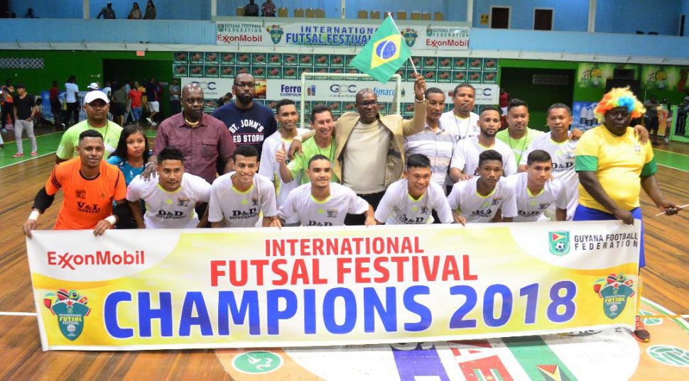 GFF President Wayne Forde [center] posing with the newly crowned ExxonMobil International Futsal Festival Champion following their 4-1 victory over Caledonia AIA of Trinidad and Tobago. Also in the photo is Director of Sports Christopher Jones. 