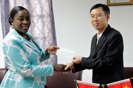 Minister of Education Nicolette Henry (left) receiving the cheque from Counsellor of the People’s Republic of China Chen Xilai. (Ministry of Education photo)
