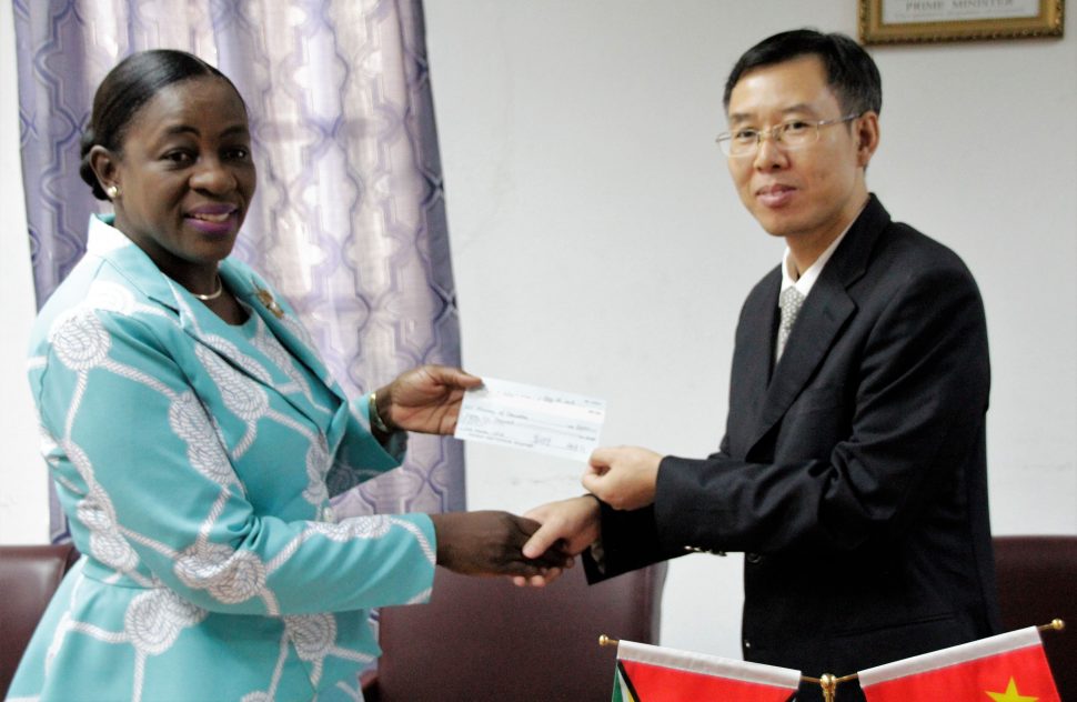 Minister of Education Nicolette Henry (left) receiving the cheque from Counsellor of the People’s Republic of China Chen Xilai. (Ministry of Education photo)



