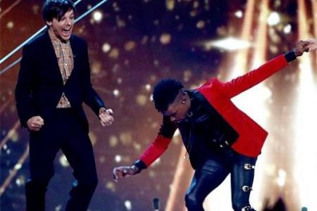 Dalton Harris reacts after being declared the winner of the 2018 UK X Factor. Judge Louis Tomlinson runs to congratulate him - Via Twitter @TheKingSource