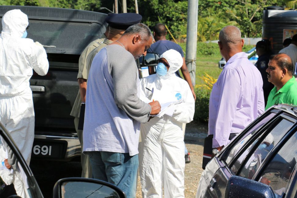 Crime Scene Investigators outside the Vega de Oropouche home home of Nathania Cadogan yesterday. Cadogan and her boyfriend were found dead by a neighbour.