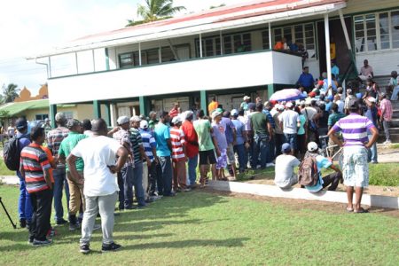 Former East Demerara Estate workers anxiously awaiting their severance payments at the Enmore Community Centre. (Department of Public Information photo)