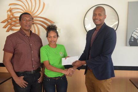 GFF representative Lakeisha Pearson (centre), receiving the sponsor’s cheque from German Restaurant Proprietor Clinton Urling. Also in the photo is Kashif and Shanghai Co-Director Kashif Muhammad. 