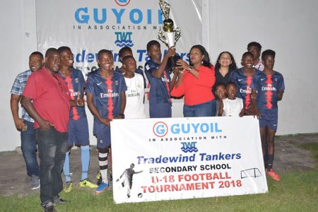 GuyOil’s Marketing and Sales Manager handing over the winner’s trophy to the Annandale captain, after the East Coast Demerara side captured the inaugural GuyOil/Tradewind Tankers U18 Secondary School Football Championship
