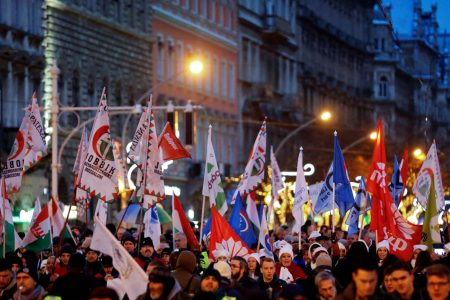 People walk with flags during a protest against a proposed new labor law, billed as the “slave law” in Budapest, Hungary, December 16, 2018. REUTERS/Leonhard Foeger
