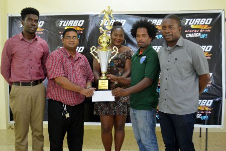 Northern Rangers Nigel Denny (second from right), collecting the championship trophy and winners cheque from Turbo Representative Raymond Govinda (second from left) in the presence of several members of tournament coordinator Petra Organization
