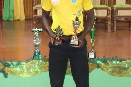 Junior Cricketer-of-the-Year, Kevin Sinclair poses with his accolades at the Guyana Cricket Board Awards Ceremony 2018 (Romario Samaroo photo)
