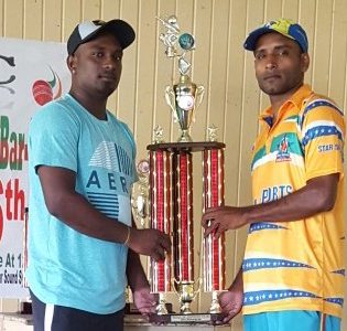 Lusignan ‘A’ vice-captain, Somdatt Bharrat (left) and Enmore CCCC captain, Beemraj Ramkelawan pose with the trophy.
