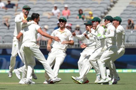 Australia’s Mitchell Starc (3rd L) is congratulated by his teammates after dismissing India’s Lokesh Rahul on day four of the second test match between Australia and India at Perth Stadium in Perth, Australia, yesterday.
