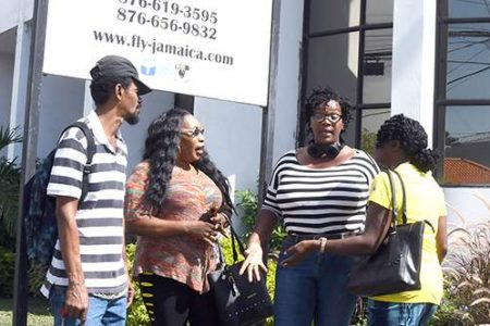 Dissatisfied Fly Jamaica Airway customers discuss the way forward, after seeking redress from the airline failed yesterday. From left are: Donavon Bunsie, Rachael Wilson, Sherryle Green and Althea Bryan. 