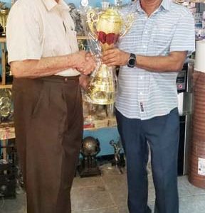 The Proprietor of the Trophy Stall, Ramesh Sunich (right) recently presented the trophies that will be awarded at the event to Justice, Cecil Kennard.
