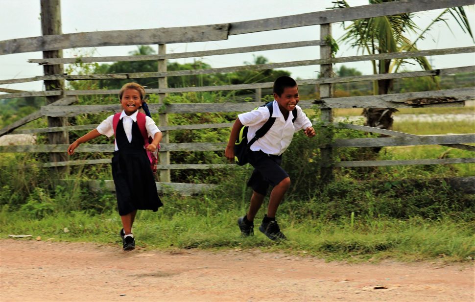 Children playing ‘ketcha’(tag) on the way home from school

