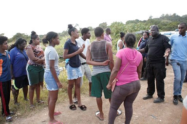 A police officer speaking to residents at the scene