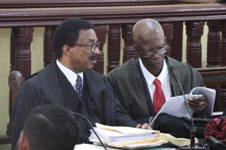 Attorney General Basil Williams SC (left) consulting with attorney Maxwell Edwards, a member of his legal team, just before the start of yesterday’s proceedings.
