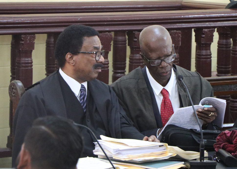 Attorney General Basil Williams SC (left) consulting with attorney Maxwell Edwards, a member of his legal team, just before the start of yesterday’s proceedings.
