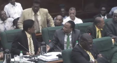 AFC backer Dereck Basdeo (standing in tan suit) confronts Charrandass Persaud after his No Confidence Vote on December 21.