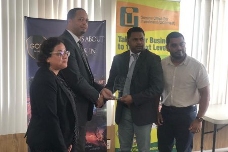 CEO of Guyana Office for Investment (GO-Invest) Owen Verwey (second, from left) receiving the award from the Georgetown Chamber of Commerce and Industry (GGCI) President Deodat Indar (second, from right) while they are flanked by GO-Invest’s Deputy CEO Natalia Seepersaud and Executive Director of GCCI Richard Rambarran (right). 