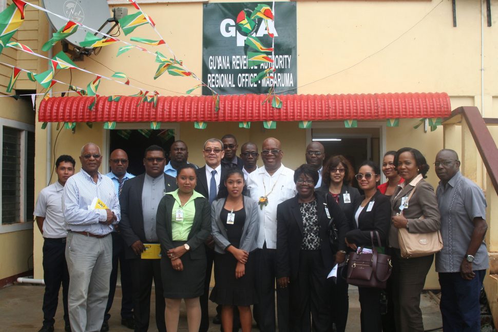 GRA officials with Minister of Finance Winston Jordan (at centre in white) and Commissioner-General Godfrey Statia (third from left in centre row) in front of the agency’s new Mabaruma office. (Photo
courtesy of GRA)
