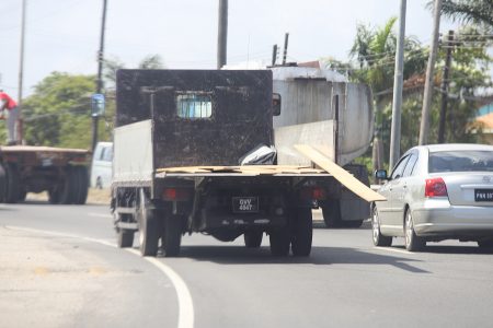 A safety hazard: Vehicles travelling along the Houston Public Road around noon yesterday had to employ evasive manoeuvres when unsecured pieces of wood started falling onto the road from the back of this truck. 