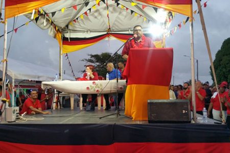 Irfaan Ali delivering his maiden speech as PPP Presidential Candidate to a gathering in his home village at Leonora, West Coast Demerara yesterday afternoon. Also in picture at the head table are Gail Teixeira, the party’s Chief Whip and General Secretary Bharrat Jagdeo. 