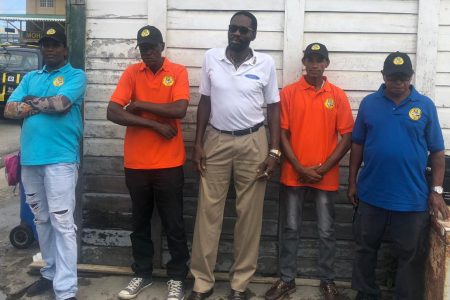 Head of the United Minibus Union (UMU) Eon Andrews (at centre) along with some of the drivers who have decided to start wearing their uniforms 