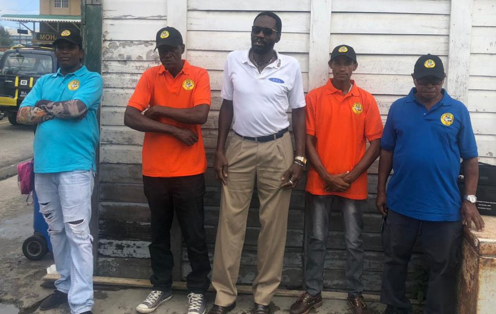 Head of the United Minibus Union (UMU) Eon Andrews (at centre) along with some of the drivers who have decided to start wearing their uniforms 