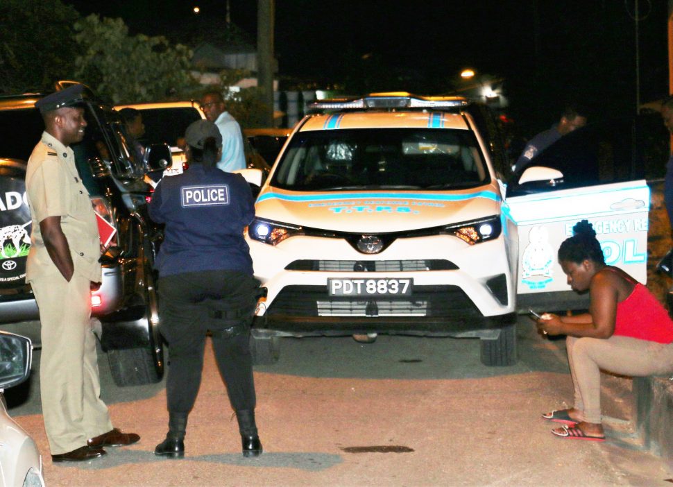 Police at the scene of the murder of coconut vendor Keith Clement on Damarie Hill Road, Sangre Grande in December.