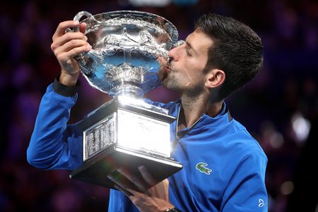 Serbia's Novak Djokovic poses with the championship trophy after winning his match against Spain's Rafael Nadal. REUTERS/Edgar Su