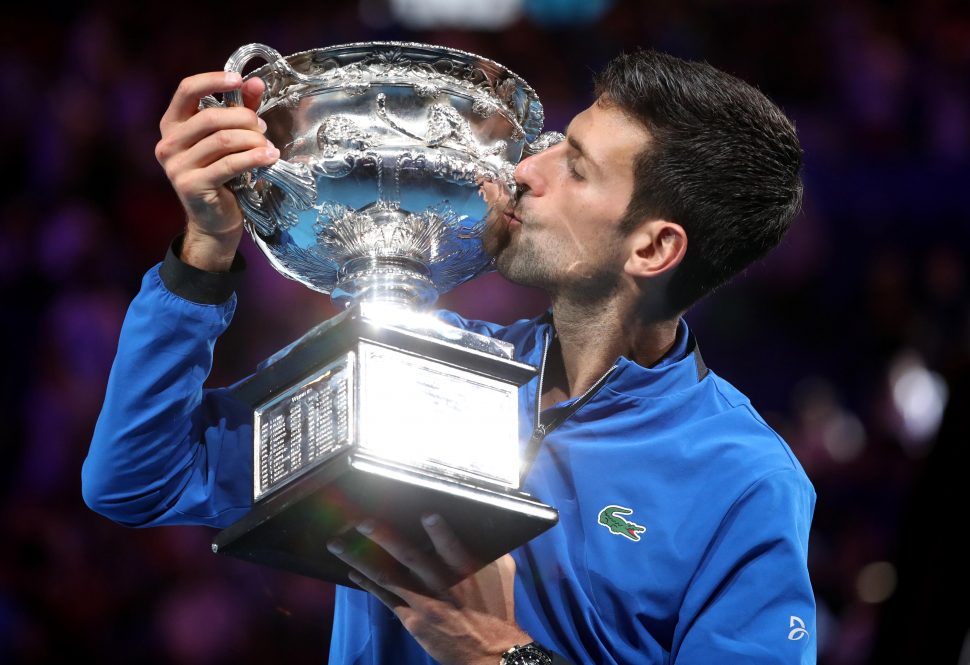 Serbia’s Novak Djokovic poses with the championship trophy after winning his match against Spain’s Rafael Nadal. REUTERS/Edgar Su