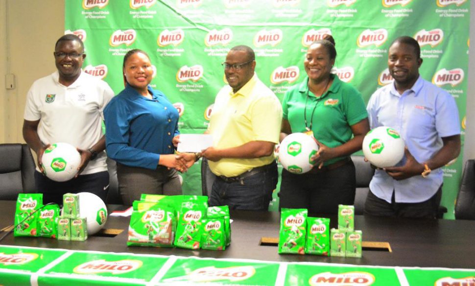 Petra Organization Co-Director Troy Mendonca receiving the sponsorship cheque from Nestle Beepat Brand Manager Shellona David following the launch of the 7th Milo Secondary Schools Football Championship. Also in the photo are GFF Youth Development Officer Bryan Joseph [left] and Petra Organization members Jacklyn Boodie and Sean Embrack
