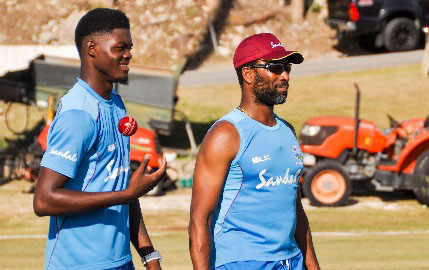 Fast bowler Alzarri Joseph (left) chats with bowling coach Corey Collymore. (Photo courtesy CWI Media)
