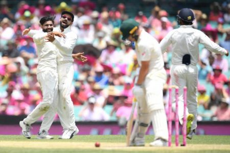 India’s Ravindra Jadeja (L) celebrates with his captain Virat Kohli after taking the wicket of Australia’s Marcus Harris on day three of the fourth test match between Australia and India at the SCG in Sydney, Australia, January 5, 2019. AAP Image/Dan...MORE