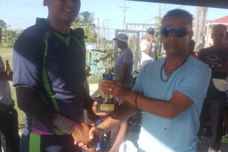 Man of the match Said Zonbia (left) receives his trophy from sponsor F. Khan
