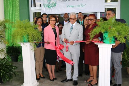 Minister of Health Terrence Deyalsingh, assisted by MP Toco/Sangre Grande Glenda Jennings-Smith, cuts the ribbon to officially open the Sangre Grande Enhanced Health Centre at Ojoe Road, Sangre Grande, yesterday.