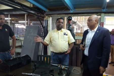 Minister of Natural Resources Raphael Trotman (right) visiting the training centre in February last year.