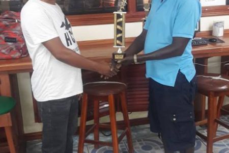 In the picture above, Sudan Ally, left, hands over one of the trophies to Mark `Jumbie’ Wiltshire on behalf of the sponsors.
