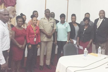 Commissioner of Police Leslie James (centre) with members of the Fallen Heroes Foundation and families who received donations on Friday. Also in photograph is Assistant Commissioner of Police Paul Williams (at left in the back row) 