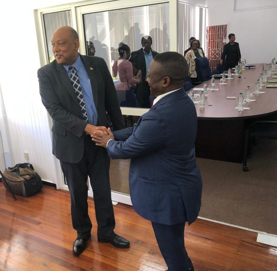 Minister of Natural Resources Raphael Trotman (left) greeting South Africa’s Deputy Minister of Mineral Resources Godfrey Oliphant yesterday morning before the start of the meeting 