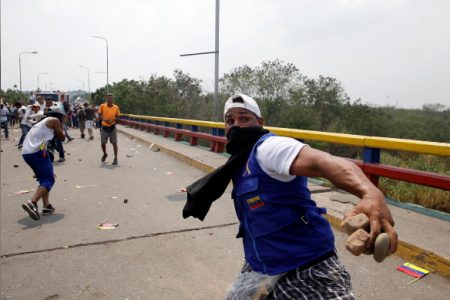 Demonstrators clash with Venezuela’s security forces at a bridge on the border line between Colombia and Venezuela as seen from Cacuta, Colombia yesterday.  REUTERS/Marco Bello 