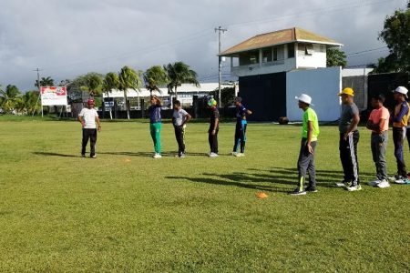 Azeemul Haniff (left) taking the young cricketers of Everest Cricket Club through their drills on Monday.
