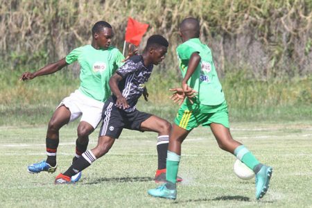 Scenes from the Bishops’ High and North Ruimveldt clash in the Milo Secondary School Football Championship at the Ministry of education ground, Carifesta Avenue yesterday.