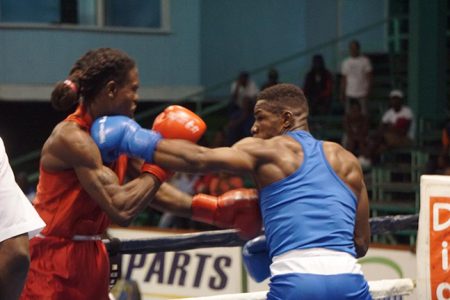 Flashback: Desmond Amsterdam (right) lands a left hand to St Lucian, Arthur Langelier in the final of the middleweight bout during the Caribbean Boxing Championships which was staged on December 6-9 at the Cliff Anderson Sports Hall.