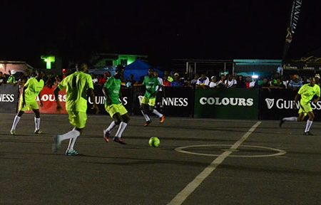 Gadi Hoyte of Brothers United in the process of receiving a pass while being tracked by several Ballers Empire players during their semi-final clash in the Guinness ‘Greatest of the Streets’ West Demerara/East Bank Demerara Championship at the Pouderoyen Tarmac Friday night.