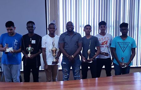 President of the Guyana Chess Federation James Bond (centre) with the winners of his Birthday Bash Celebratory Chess Tournament, which was held on Saturday, February 2. Bond created a one-day, 12-round Blitz Chess Tournament to honour the nation’s youth who adore the speed chess phenomenon. On Bond’s right are the Seniors: Anthony Drayton, Davion Mars and Roberto Neto and on his left, the Juniors: Andre Jagnandan, Saeed Ali and Joshua Gopaul, representing first to third in both categories.