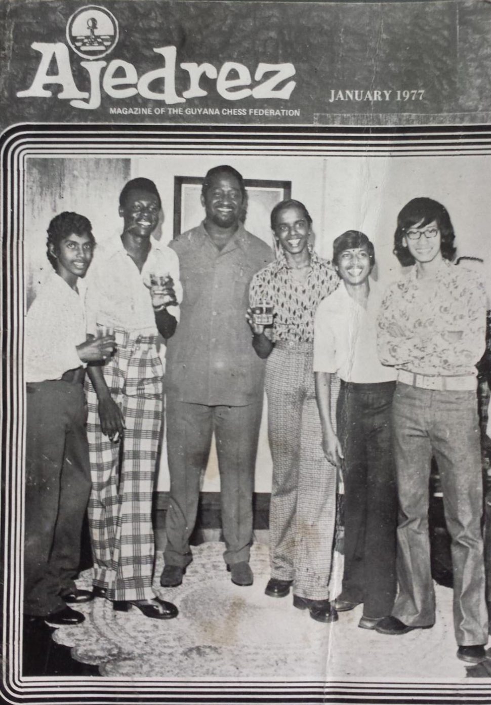 Flashback! This was the cover of the January 1977 chess magazine Ajedrez which was published by the Guyana Chess Federation. President of the federation Burnham is at centre. The occasion was a cocktail reception at the Residence for the first presentation of the Burnham Trophy to the winner of the National Chess Championship. From left are: Nigel Jagan, Wendell Jackman, Aftab Karimullah, Roy Khan and Michael Chan.  

