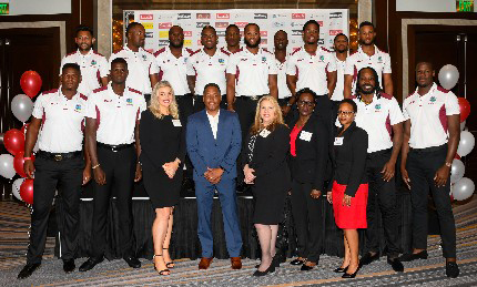The West Indies one-day team pose with officials of Colonial Group International.