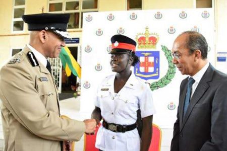 Commissioner of Police Antony Anderson congratulates Constable Donique Anderson who was the only female among the 196 recruits who graduated from the National Police College of Jamaica in Twickenham Park, St Catherine yesterday. 