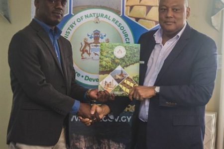 Senior Technical Director of Conservation International Guyana, Curtis Bernard (left) receiving the MoU from Minister of Natural Resources, Raphael Trotman (Department of Public Information photo)

