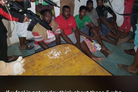 Kidnappers train their guns at five of the six Trinidad & Tobago fishermen who were reportedly abducted and taken to Venezuela. The victims were from left Brandon Arjoon, Jason O'Brian , Jagdesh Jude Jaikaran, Jerry O'Brian , Linton Manohar and missing from photo Ricky Rambharose.